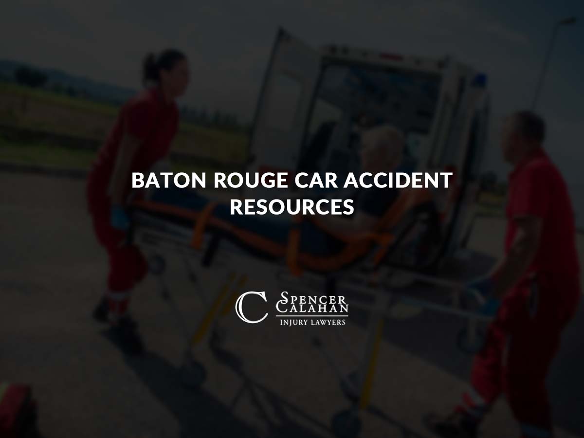 EMT's putting person on a gurney into an ambulance. Text overlay: Baton Rouge Car Accident Resources