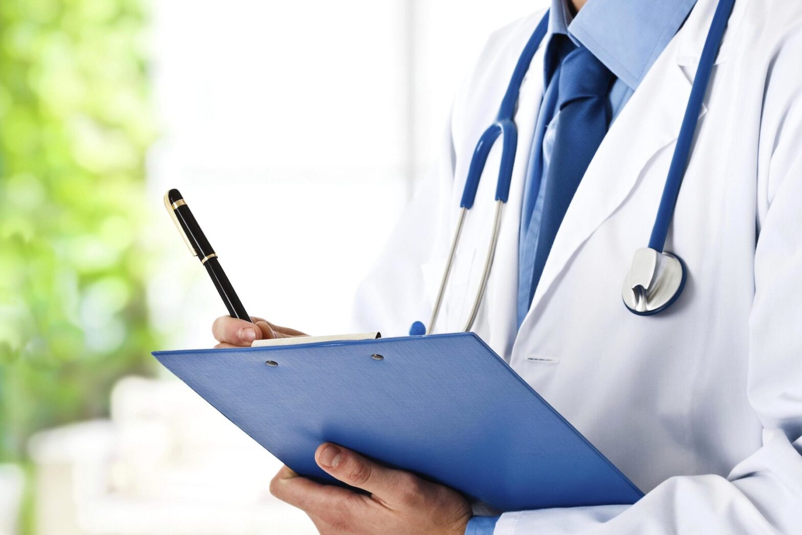 Doctor writing information for a medical malpractice lawyer